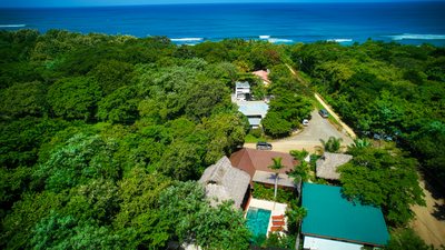 Aerial view of Johnny's Beach Bungalow and its pool set in jungle near Playa Avellanas