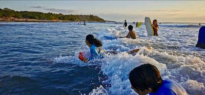 Children bodyboarding in the shorebreak at Playa Avellanas