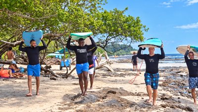 Carrying boards back up the beach