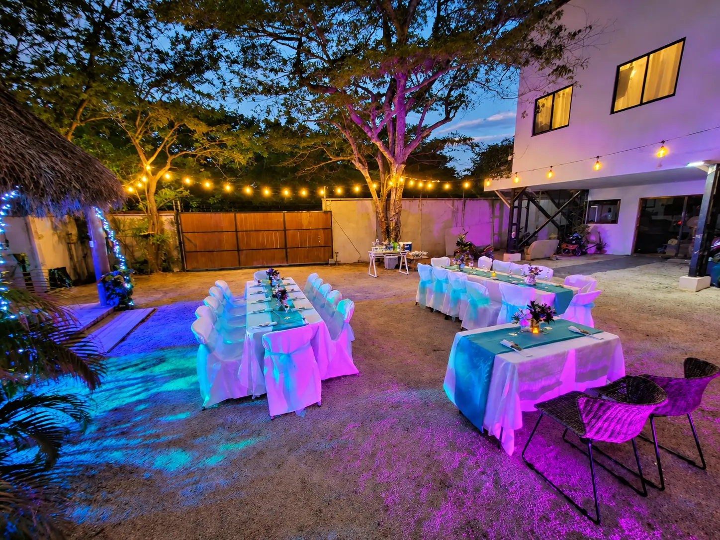 Evening wedding reception under string lights in the courtyard at Johnny's Beach Bungalow